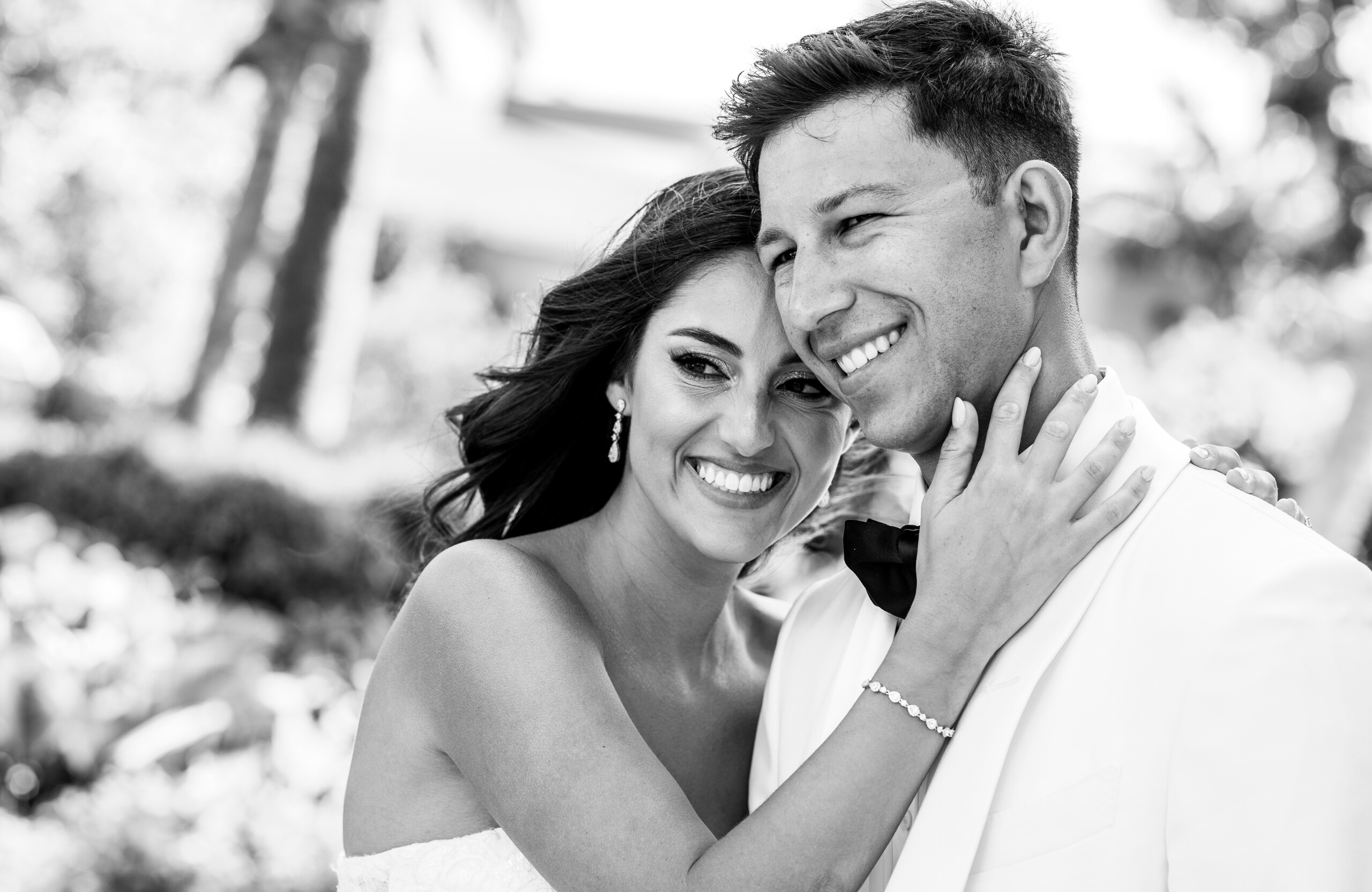 black and white photo of bride and groom smiling