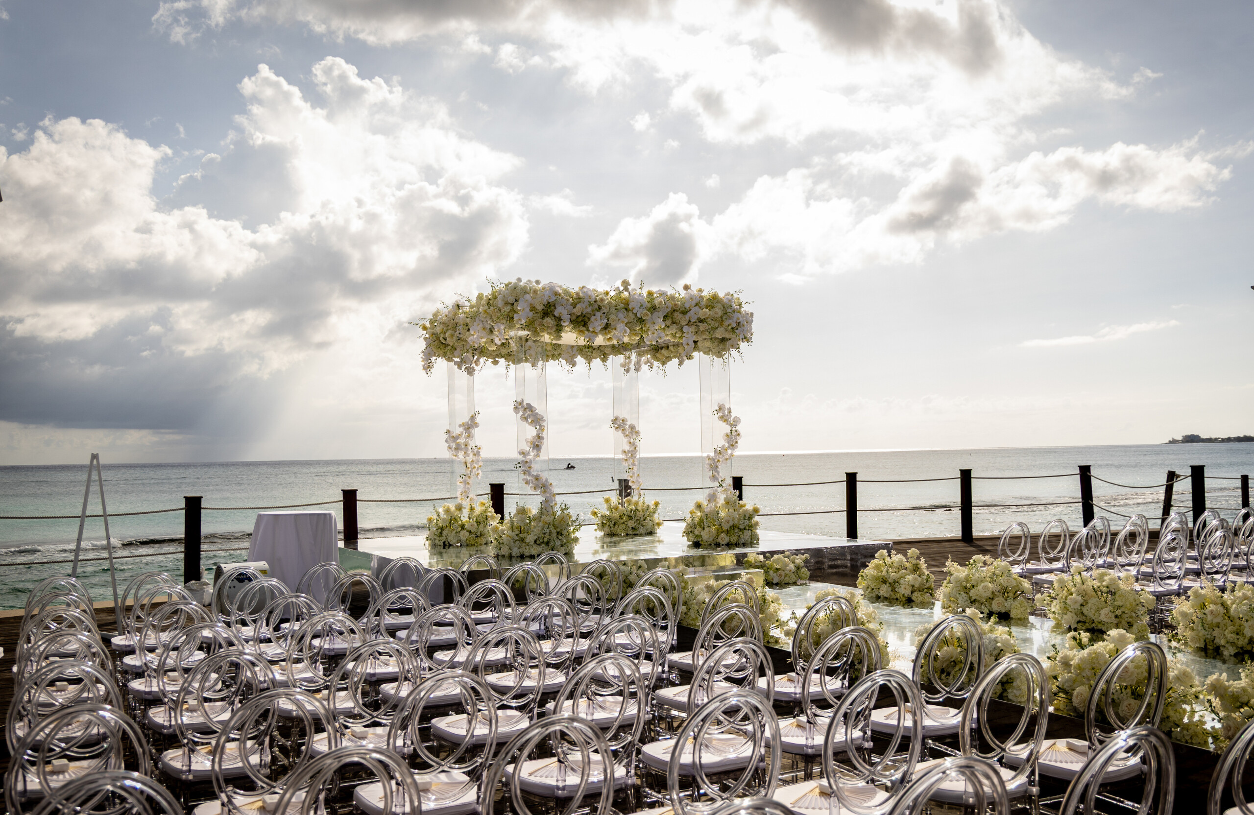 oceanfront wedding ceremony in Grand Cayman with white floral decor