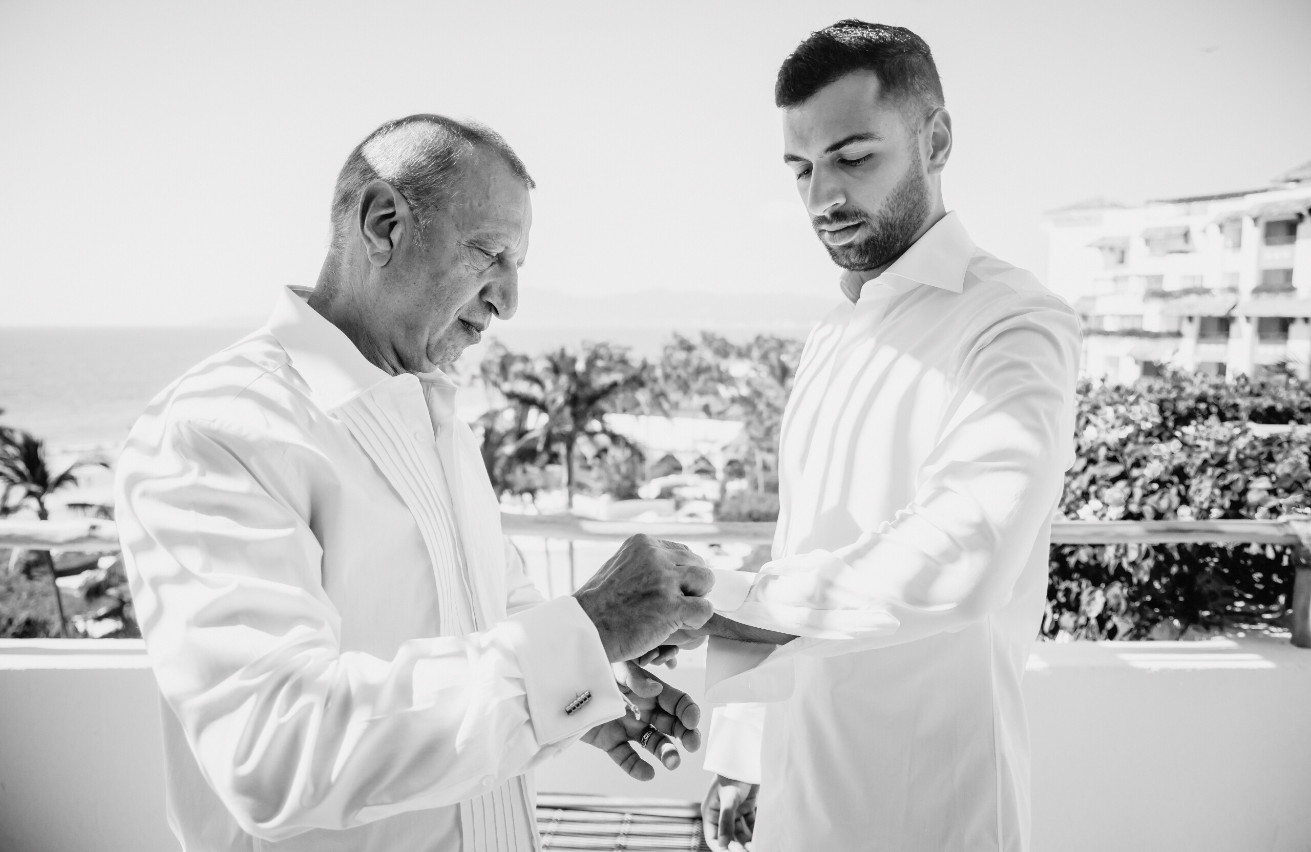 black and white photo of groom getting ready before wedding