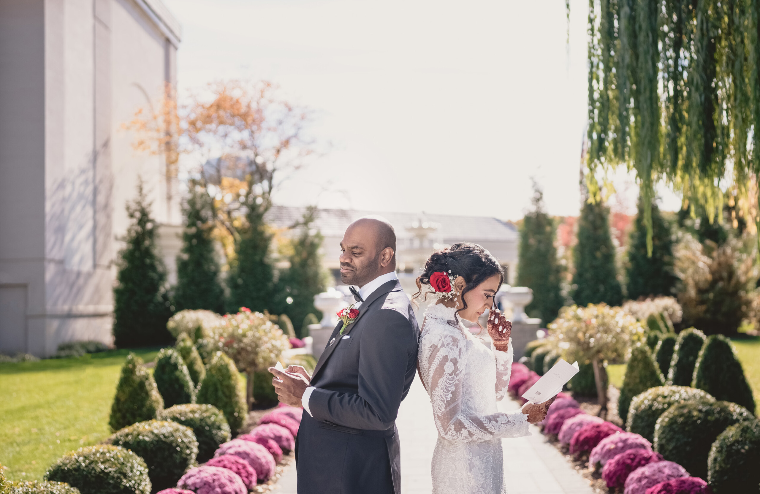 bride and groom standing back to back