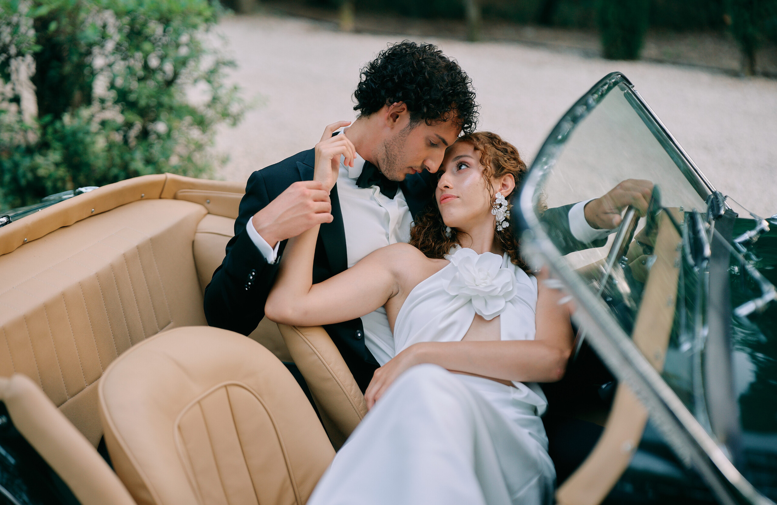 bride and groom in classic car