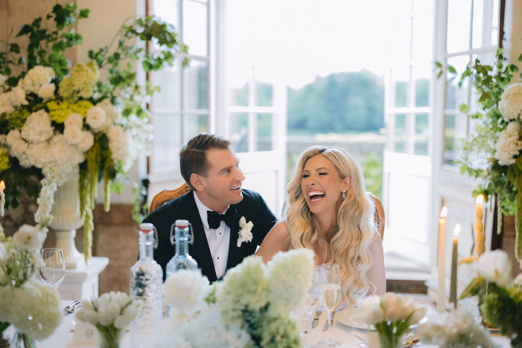 bride and groom laughing during wedding reception