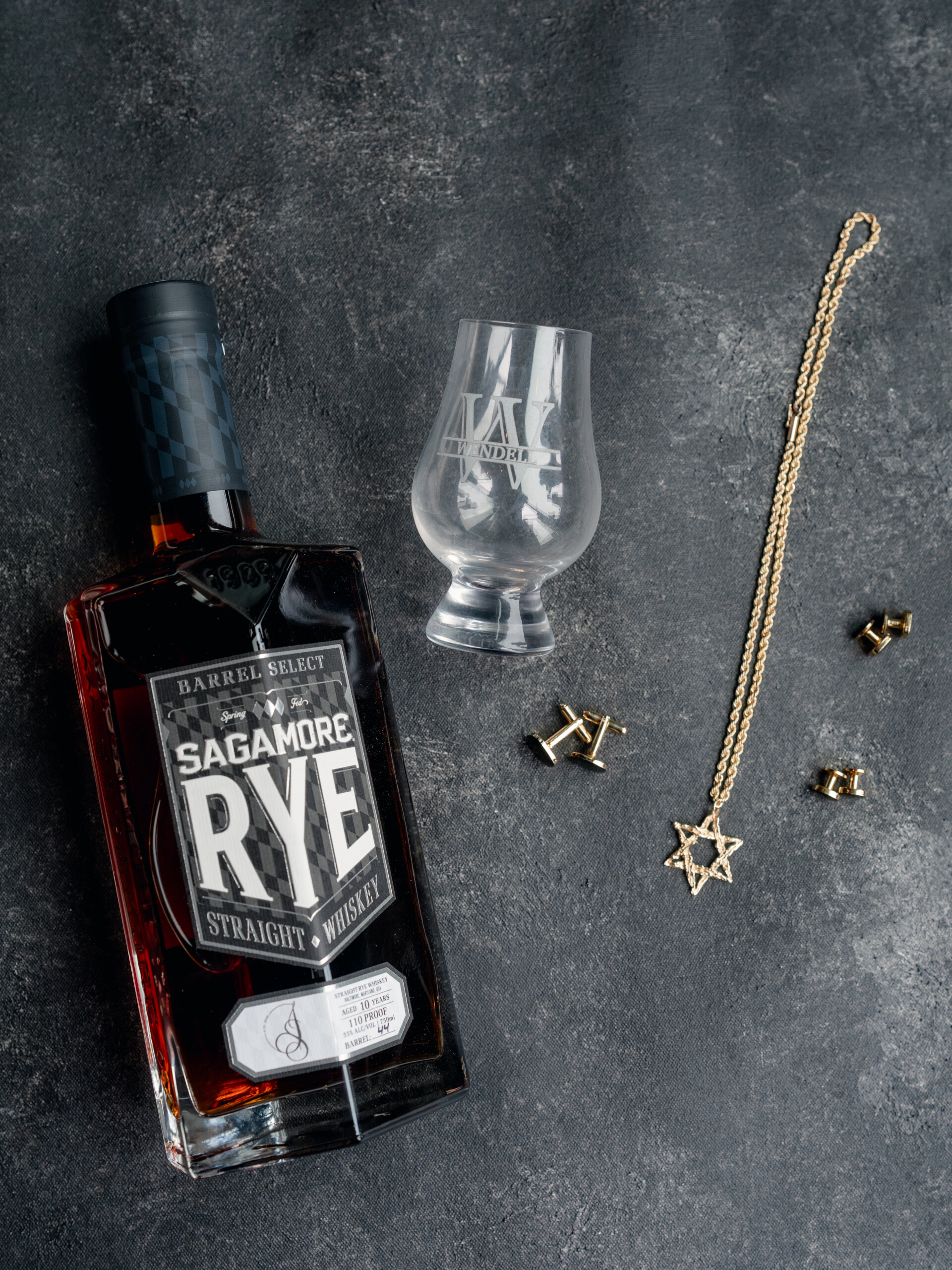 TW_01338 custom bourbon bottles and groom's accessories flat lay