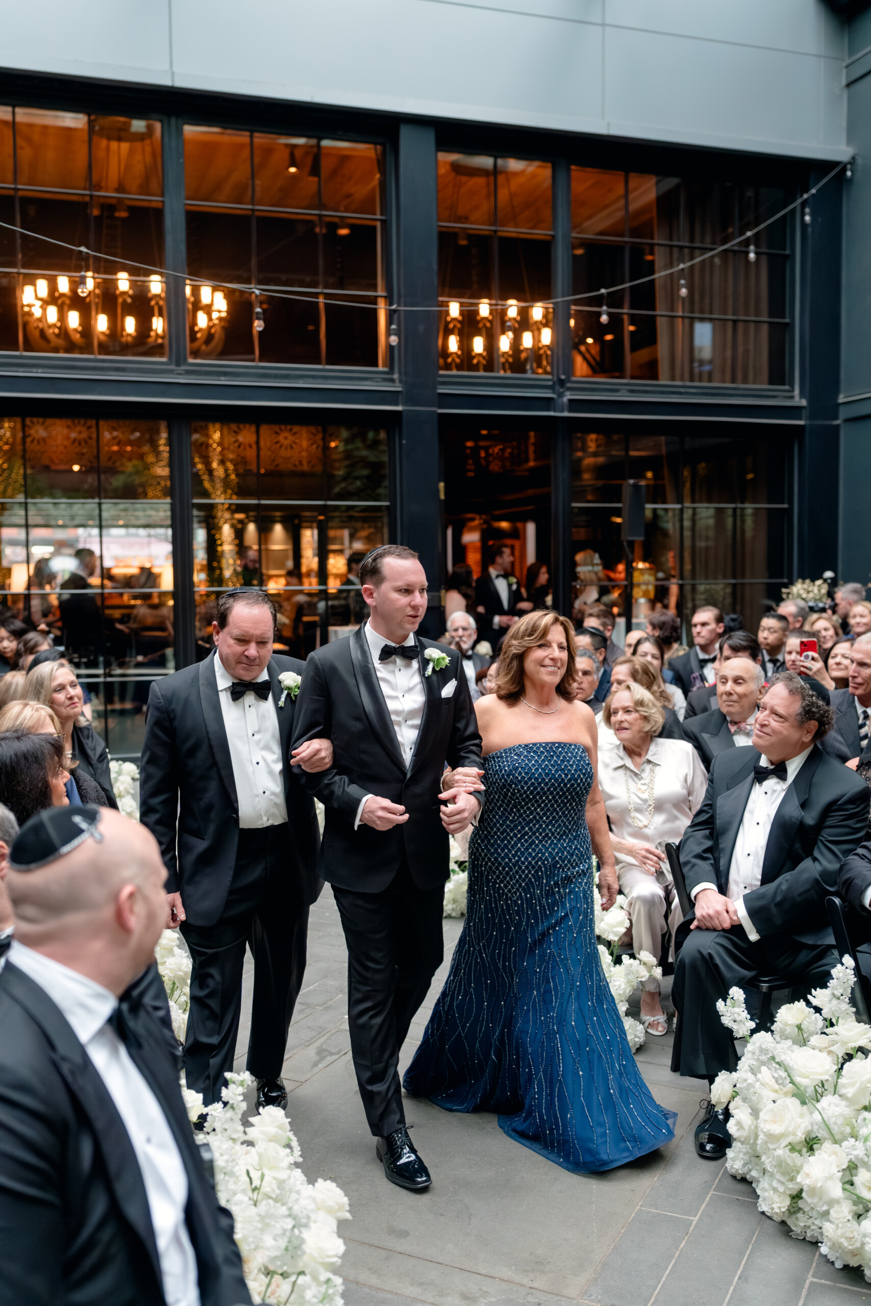 TW_02389 groom walking down aisle with parents